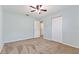 Spacious bedroom with light blue walls, carpeted floors, and a double door closet and open doorway at 1712 Melvin Ave, Orlando, FL 32806
