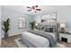 Stylishly furnished bedroom featuring a ceiling fan, neutral tones, and ample natural light from the window at 1712 Melvin Ave, Orlando, FL 32806