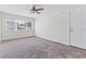 This bedroom offers a neutral color scheme with new carpet and a bright window at 1712 Melvin Ave, Orlando, FL 32806
