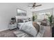 Bright, comfortable bedroom featuring ample natural light, neutral decor, a ceiling fan, and cozy seating at 1712 Melvin Ave, Orlando, FL 32806