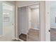 This is a view of closet space near a bedroom with mirrored sliding doors and wood-look flooring at 1712 Melvin Ave, Orlando, FL 32806