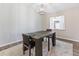 Dining room with stylish table set beneath a modern light fixture and a large window with curtains at 1712 Melvin Ave, Orlando, FL 32806