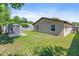 Exterior of home with storage shed and lawn at 1712 Melvin Ave, Orlando, FL 32806