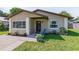 Charming single-story home featuring a cozy front porch, well-maintained lawn, and a welcoming entrance at 1712 Melvin Ave, Orlando, FL 32806