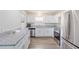 Stylish kitchen featuring stainless steel appliances, white cabinets, granite countertops, and modern flooring at 1712 Melvin Ave, Orlando, FL 32806