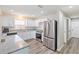 Bright, modern kitchen features stainless steel appliances, granite countertops, and new flooring at 1712 Melvin Ave, Orlando, FL 32806