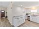 Modern kitchen boasts granite countertops, stainless steel appliances, and pristine white cabinetry at 1712 Melvin Ave, Orlando, FL 32806