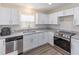 Well-lit kitchen featuring granite countertops, modern stainless steel appliances, and new flooring at 1712 Melvin Ave, Orlando, FL 32806