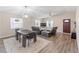 Open-concept living room with a wood floor, a modern table set, and lots of natural light at 1712 Melvin Ave, Orlando, FL 32806
