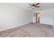 Living room features neutral walls and carpet with a view to the kitchen and a side door at 1712 Melvin Ave, Orlando, FL 32806