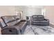 A spacious living room with a stylish wood-tone floor, modern table set, and open to the kitchen at 1712 Melvin Ave, Orlando, FL 32806