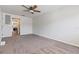 Spacious living room featuring neutral walls and carpet with a view into the kitchen at 1712 Melvin Ave, Orlando, FL 32806