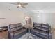 Spacious living room featuring a modern ceiling fan and furnishings, seamlessly connecting to an open kitchen at 1712 Melvin Ave, Orlando, FL 32806