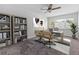 Bright office features a ceiling fan, large desk area, and bookshelves perfect for working from home at 1712 Melvin Ave, Orlando, FL 32806