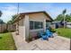 Exterior side view of a cozy home with a well-kept lawn, and concrete walkway at 1712 Melvin Ave, Orlando, FL 32806