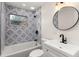 Cozy bathroom showcasing patterned tile shower, sleek fixtures, and a vanity at 1842 Puritan Ave, Winter Park, FL 32792