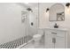 Stylish bathroom with glass shower, patterned tile, sleek black fixtures and vanity at 1842 Puritan Ave, Winter Park, FL 32792
