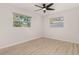 Bright bedroom features sleek ceiling fan, wood floors and dual windows for natural light at 1842 Puritan Ave, Winter Park, FL 32792