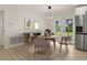 Dining area with modern lighting and a view of the backyard through double doors at 1842 Puritan Ave, Winter Park, FL 32792