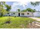 Charming single-story home with a manicured lawn, mature trees, and welcoming entrance at 1842 Puritan Ave, Winter Park, FL 32792