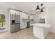 Modern kitchen with stainless steel appliances, white cabinets, and a stylish backsplash at 1842 Puritan Ave, Winter Park, FL 32792