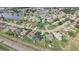 Aerial view showcasing homes near lakes and a highway, highlighting location and community at 2410 Sweetwater Blvd, St Cloud, FL 34772