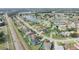 Drone's-eye view featuring houses nestled near a lake and main road, emphasizing community at 2410 Sweetwater Blvd, St Cloud, FL 34772