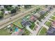Aerial view of homes with pools, solar panels and well-maintained lawns, alongside a multi-lane road at 2410 Sweetwater Blvd, St Cloud, FL 34772