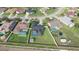 Aerial view of homes with backyard pools and well-kept lawns, situated in a quiet residential neighborhood at 2410 Sweetwater Blvd, St Cloud, FL 34772