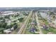 Expansive aerial view of a residential neighborhood featuring homes with manicured lawns and scenic ponds at 2410 Sweetwater Blvd, St Cloud, FL 34772