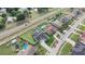 Aerial view of homes with pools, solar panels and well-maintained lawns, alongside a multi-lane road at 2410 Sweetwater Blvd, St Cloud, FL 34772