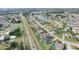 Drone image showing houses, lakes, and a roadway, indicating an established community at 2410 Sweetwater Blvd, St Cloud, FL 34772