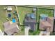 Overhead view of residential area with swimming pools, green lawns, and surrounding community at 2410 Sweetwater Blvd, St Cloud, FL 34772