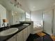 Inviting bathroom with a soaking tub and a large mirror reflecting the spacious layout at 2410 Sweetwater Blvd, St Cloud, FL 34772
