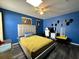 Stylish bedroom featuring bright blue walls, a modern bed frame, and a ceiling fan at 2410 Sweetwater Blvd, St Cloud, FL 34772
