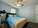 This bedroom features a beach themed comforter set and decor, with dark wood floors at 2410 Sweetwater Blvd, St Cloud, FL 34772