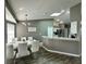 Stylish dining area with a modern chandelier, seating for six, and an open view to the kitchen at 2410 Sweetwater Blvd, St Cloud, FL 34772