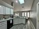 Well-lit kitchen featuring white cabinets, granite countertops, and modern appliances at 2410 Sweetwater Blvd, St Cloud, FL 34772