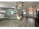 Bright living room featuring an open floor plan, modern flooring, and a cozy recliner at 2410 Sweetwater Blvd, St Cloud, FL 34772