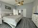 Spacious bedroom with sliding glass doors and a stylish white and light gray color palette at 2410 Sweetwater Blvd, St Cloud, FL 34772