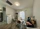 Bright home office featuring a glass-top desk, ample storage, and a comfortable seating arrangement at 2410 Sweetwater Blvd, St Cloud, FL 34772
