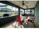 Relaxing screened patio with tile floors, ceiling fans, and views of the pool at 2410 Sweetwater Blvd, St Cloud, FL 34772