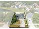 An aerial view showcases the property's mature landscaping and convenient neighborhood location at 2454 Quail Run N Blvd, Kissimmee, FL 34744