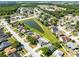 An aerial view of the neighborhood, showcasing the community's layout near the lake at 2454 Quail Run N Blvd, Kissimmee, FL 34744