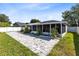 Spacious backyard with a screened-in patio and beautiful paver stones at 2454 Quail Run N Blvd, Kissimmee, FL 34744