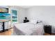 Bedroom with hardwood flooring, a large window, and a flat screen TV at 2454 Quail Run N Blvd, Kissimmee, FL 34744