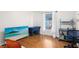 Bright bedroom featuring wood floors and a large window at 2454 Quail Run N Blvd, Kissimmee, FL 34744