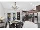 Bright dining area next to the kitchen, featuring stainless steel appliances at 2454 Quail Run N Blvd, Kissimmee, FL 34744