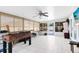Large sunroom with tile flooring, a ceiling fan, and sliding glass doors to the outside at 2454 Quail Run N Blvd, Kissimmee, FL 34744