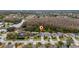 Aerial view of the property highlighting its location near a pond and wooded area at 2507 Talega Dr, St Cloud, FL 34772